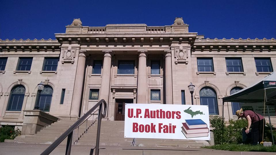 UPPAA A sign that says upz authors book fair in front of a building.