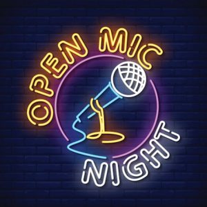 UPPAA Neon sign advertising "open mic night" featuring a microphone, against a brick wall background.