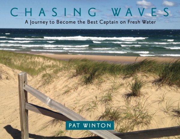 UPPAA Cover of the book "Chasing Waves" by Pat Winton, showing sandy dunes, grass, a wooden railing, and a wavy freshwater lake under a blue sky with clouds. Subheading reads: "A Journey to Become the Best Captain on Fresh Water.